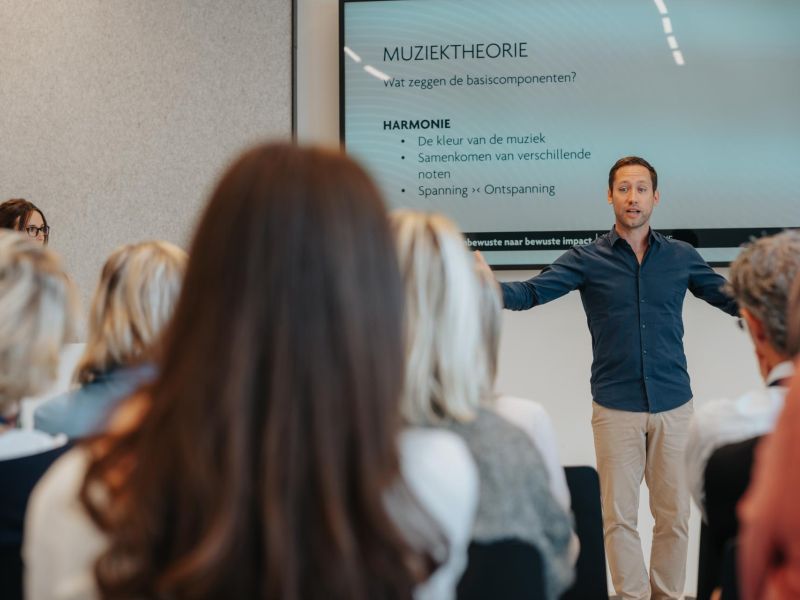 Pieter van De Muzieksommelier licht muziektheorie toe tijdens de keynote Muziek en het brein